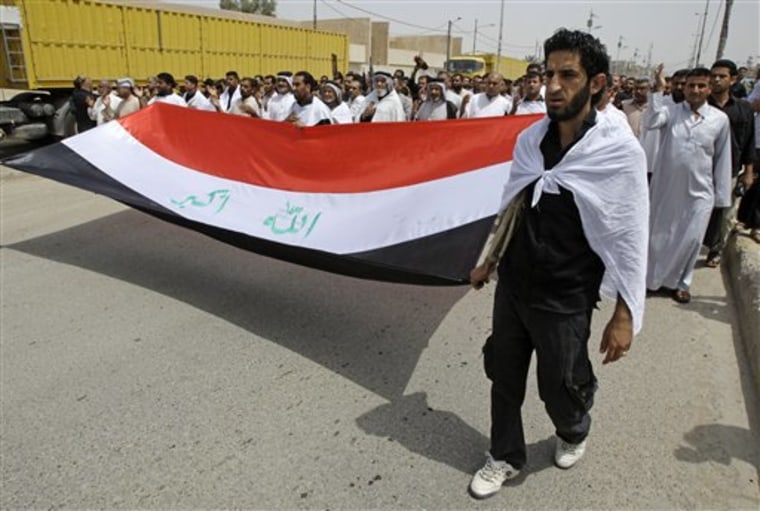 Followers of radical Shiite Cleric Muqtada al-Sadr wear white shrouds to signal their readiness for martyrdom as they march in the Sadr City neighborhood of Baghdad, Iraq, on April 30.